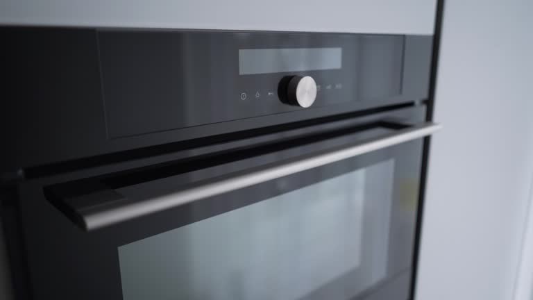 Close-up view of a modern built-in oven with a digital control panel and stainless steel handle.