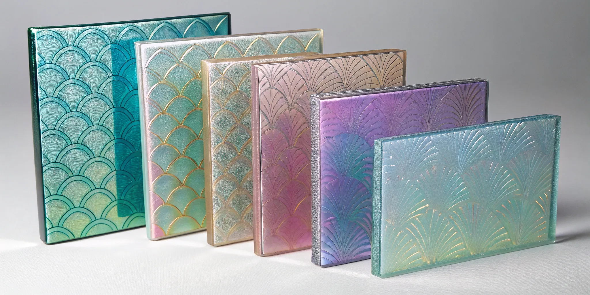 Etched dichroic glass with intricate patterns revealing shifting, iridescent colors.
